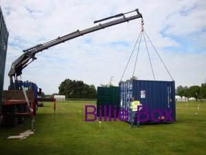 shipping container being delivered by crane