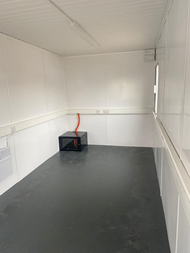 Interior of hospital site office and canteen converted shipping container.