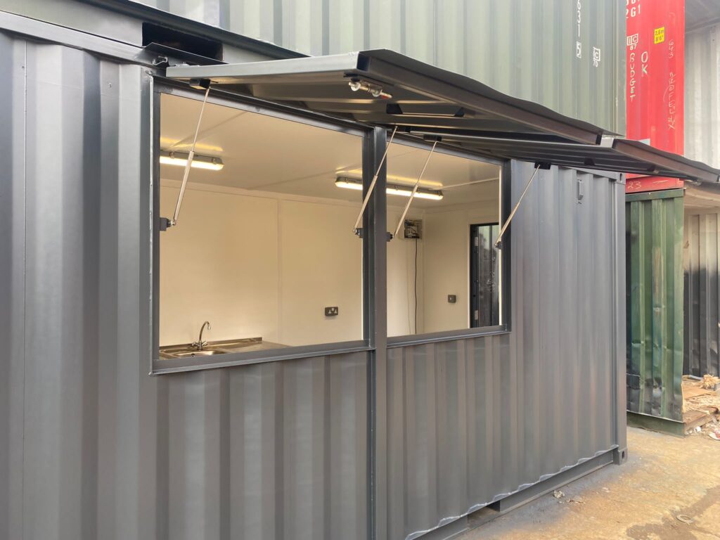 School Snack Shack converted shipping container exterior, showing serving hatch open.